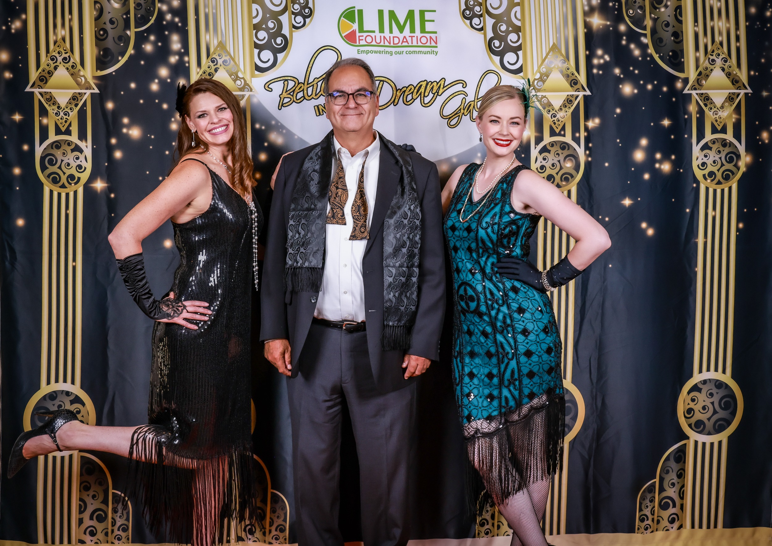 Three people posing for a photo at a 1920s themed party held by The LIME Foundation of Santa Rosa.