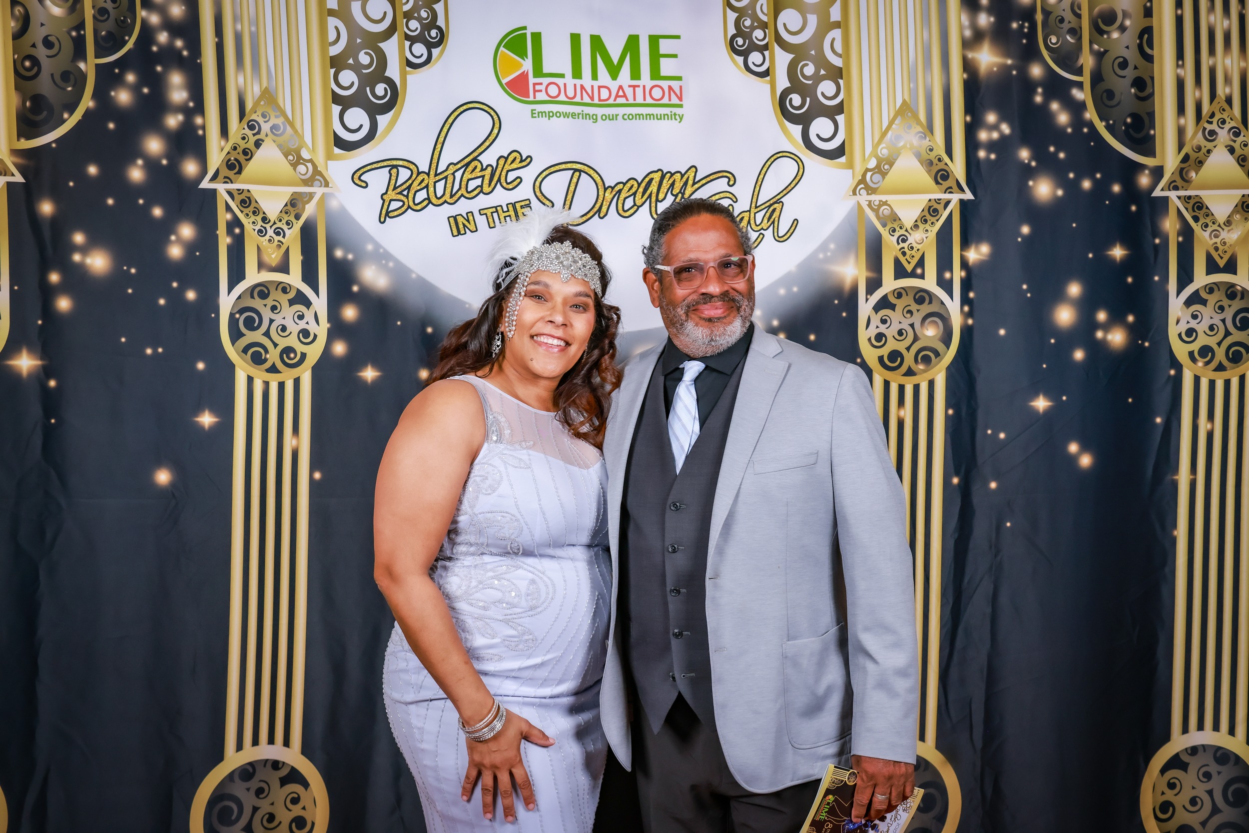 A man and woman posing for a photo at a party hosted by The LIME Foundation of Santa Rosa, a Sonoma County Non-Profit Organization.