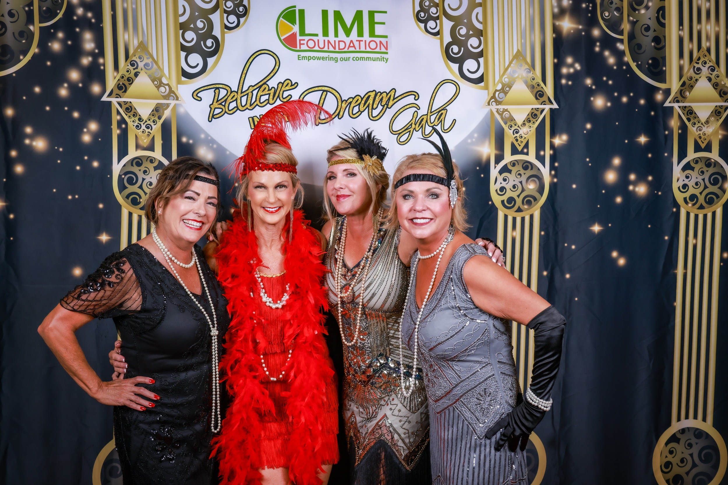A group of women in flapper costumes posing for a photo at an event hosted by The LIME Foundation of Santa Rosa.